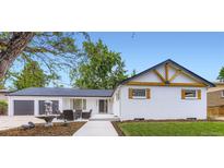 Charming exterior with white brick, modern dark trim, 2 car garage and inviting front patio at 6537 Everett St, Arvada, CO 80004