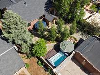 Aerial shot of a backyard with a pristine hot tub, surrounded by lush greenery and serene landscaping at 405 S University Blvd, Denver, CO 80209