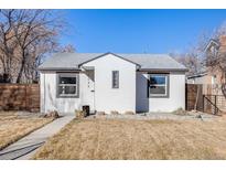 Charming, renovated bungalow featuring stucco siding, modern windows, and a well-maintained front yard at 2645 Jasmine St, Denver, CO 80207