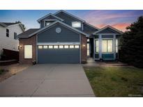 Charming two-story home featuring a two-car garage, manicured lawn and welcoming entryway at 16839 Trail View Cir, Parker, CO 80134