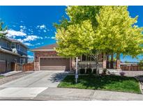 Charming brick home featuring a well-manicured front yard and an attached two-car garage at 4385 Oakes Mill Ct, Castle Rock, CO 80109