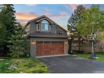 Charming two-story home with a well-manicured lawn and a two-car garage at 24005 High Meadow Dr, Golden, CO 80401