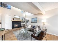 Bright living room boasts a cozy fireplace, high ceilings and a large window at 186 S Nome St, Aurora, CO 80012