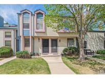 Charming townhome featuring a well-maintained lawn, mature tree, and inviting front entrance at 16104 E Alaska Pl # D, Aurora, CO 80017