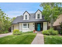 Charming two-story home with a well-maintained front yard, stone walkway, and inviting blue front door at 1016 S Cook St, Denver, CO 80209
