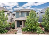 Charming two-story home featuring professionally landscaped front yard and welcoming front porch at 8768 E 54Th Pl, Denver, CO 80238