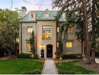 Elegant home boasts a classic design with a beautiful yard and distinctive architectural details at 165 N High St, Denver, CO 80218