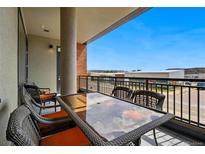 Relaxing outdoor balcony features patio seating with neighborhood views under a clear blue sky at 20 Wilcox St # 208, Castle Rock, CO 80104