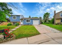 Charming two-story home with a well-maintained front yard and attached one-car garage at 4259 S Richfield St, Aurora, CO 80013