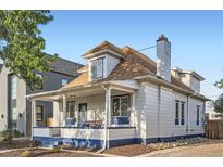 Quaint two-story home showcasing a front porch, clean lines, and inviting curb appeal at 2426 S Acoma St, Denver, CO 80223