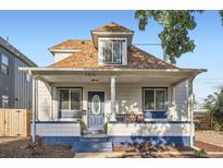 Charming home showcasing a cozy front porch and blue and white exterior paint at 2426 S Acoma St, Denver, CO 80223