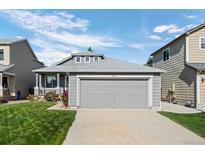 Charming home featuring a spacious two-car garage with a well-maintained lawn and inviting curb appeal at 8761 Cloverleaf Cir, Parker, CO 80134