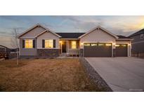 Charming two-story home boasts great curb appeal, neutral paint, stone accents, three-car garage and meticulously manicured lawn at 6766 Mentha Dr, Castle Rock, CO 80108