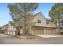 Inviting townhouse complex with well-maintained landscaping and attached garages on a sunny day at 1661 S Fulton St, Aurora, CO 80247