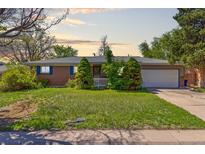 Charming single-story home featuring a well-maintained lawn and a two-car attached garage at 430 S Potomac Cir, Aurora, CO 80012