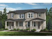 Charming townhome with a covered front porch and well-maintained landscaping at 28636 E 6Th Pl, Watkins, CO 80137