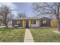 Charming single-story home with a well-manicured lawn and a welcoming entryway showcasing curb appeal at 6105 Lamar St, Arvada, CO 80003