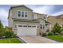 Charming two-story home features a two-car garage and well-manicured lawn at 6883 E 132Nd Pl, Thornton, CO 80602
