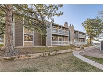 Charming condo featuring stone accents, private balconies, and mature trees at 18043 E Ohio Ave # 202, Aurora, CO 80017