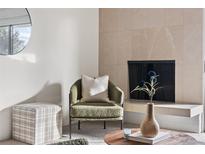 Bright living room with fireplace, and sliding glass door to balcony at 1313 N Williams St # 703, Denver, CO 80218