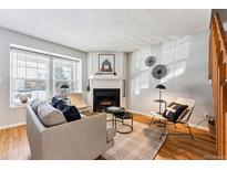 Bright living room with fireplace, neutral decor, and hardwood floors at 4626 S Dillon Ct # B, Aurora, CO 80015