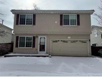 Two-story home featuring a two-car garage, charming front entrance, and traditional window shutters at 20000 E Mitchell Pl # 34, Denver, CO 80249
