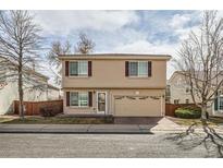 Two-story home with a two-car garage, manicured lawn, and beautiful landscaping at 20000 E Mitchell Pl # 34, Denver, CO 80249