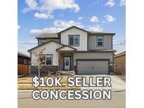 Charming two-story home with a manicured lawn and attached two-car garage in a suburban neighborhood at 8852 Ventura St, Commerce City, CO 80022