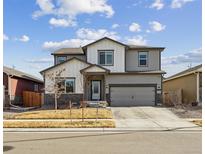 Charming two-story home with neutral paint, stone accents, and a spacious two-car garage at 8852 Ventura St, Commerce City, CO 80022