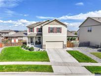 Charming two-story home with a well-manicured lawn and a welcoming two-car garage at 562 Gallo St, Brighton, CO 80603