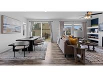 Bright living room featuring an open layout, modern furniture, and abundant natural light at 17960 Weymouth Ave, Parker, CO 80134