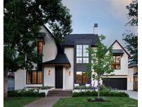 Striking two-story home featuring a modern design with a manicured lawn and beautiful landscaping at 346 Elm St, Denver, CO 80220