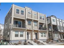 Contemporary townhome with stone accents, private balconies, and a well-maintained front entrance at 8500 W 62Nd Ave # D, Arvada, CO 80004