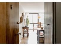 Entryway view showcasing an inviting space with hardwood floors and dining area at 1050 N Corona St # 312, Denver, CO 80218