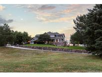 Expansive home boasts meticulous landscaping, a long drive, and stunning curb appeal at 5604 Singletree Ln, Parker, CO 80134