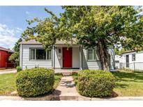 Charming single-Gathering home with a well-maintained lawn, mature tree, and a bright red front door at 745 S Utica St, Denver, CO 80219