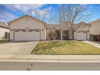 Charming single-story home featuring a two-car garage and well-maintained front yard at 20630 E Ithaca Pl, Aurora, CO 80013