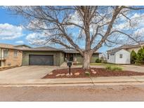 Charming single-story home with well-maintained lawn, mature trees, and attached two car garage at 5761 W 50Th Ave, Denver, CO 80212