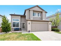Charming two-story home with a well-maintained front yard, attached two-car garage and covered front porch at 10512 Hyacinth St, Highlands Ranch, CO 80129