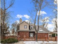 Brick house with a fenced yard and mature trees at 4401 S Lincoln St, Englewood, CO 80113