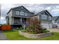 Beautiful two-story home featuring a well-manicured lawn and stone accents at 5895 E Conservation Dr, Frederick, CO 80504