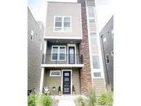Modern three-story home with stone accents and a balcony at 3521 Mykonos Dr, Castle Rock, CO 80109