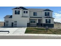 Charming two-story home with a three-car garage, blue roof accents, and landscaped yard at 42980 Colonial Trl, Elizabeth, CO 80107