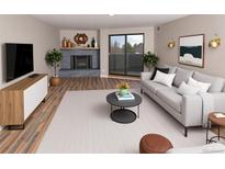 Bright living room features a fireplace, balcony access, and modern decor for a comfortable and stylish space at 7255 E Quincy Ave # 205, Denver, CO 80237