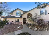 Townhouse exterior with landscaping and walkway at 8671 E Dry Creek Rd # 721, Englewood, CO 80112