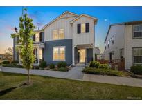 Charming two-story home with blue and white exterior, small front yard, and well-maintained landscaping at 8586 Holman Ct # A, Arvada, CO 80005