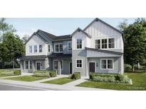 Charming two-story townhome with a modern farmhouse facade, lush landscaping, and inviting curb appeal at 6639 Parterre N Pkwy # 3, Thornton, CO 80602