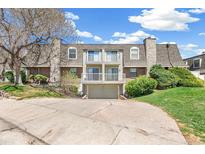 Inviting multi-story townhome featuring a two-car garage and a cozy balcony on a sunny day at 1350 S Idalia St # G, Aurora, CO 80017