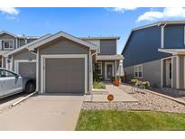 Charming two-story home with a well-maintained lawn, a driveway, and a one car garage at 11062 Gaylord St, Northglenn, CO 80233