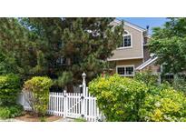 Charming home with a white picket fence and lush landscaping, creating a welcoming curb appeal at 2560 Concord Cir, Lafayette, CO 80026